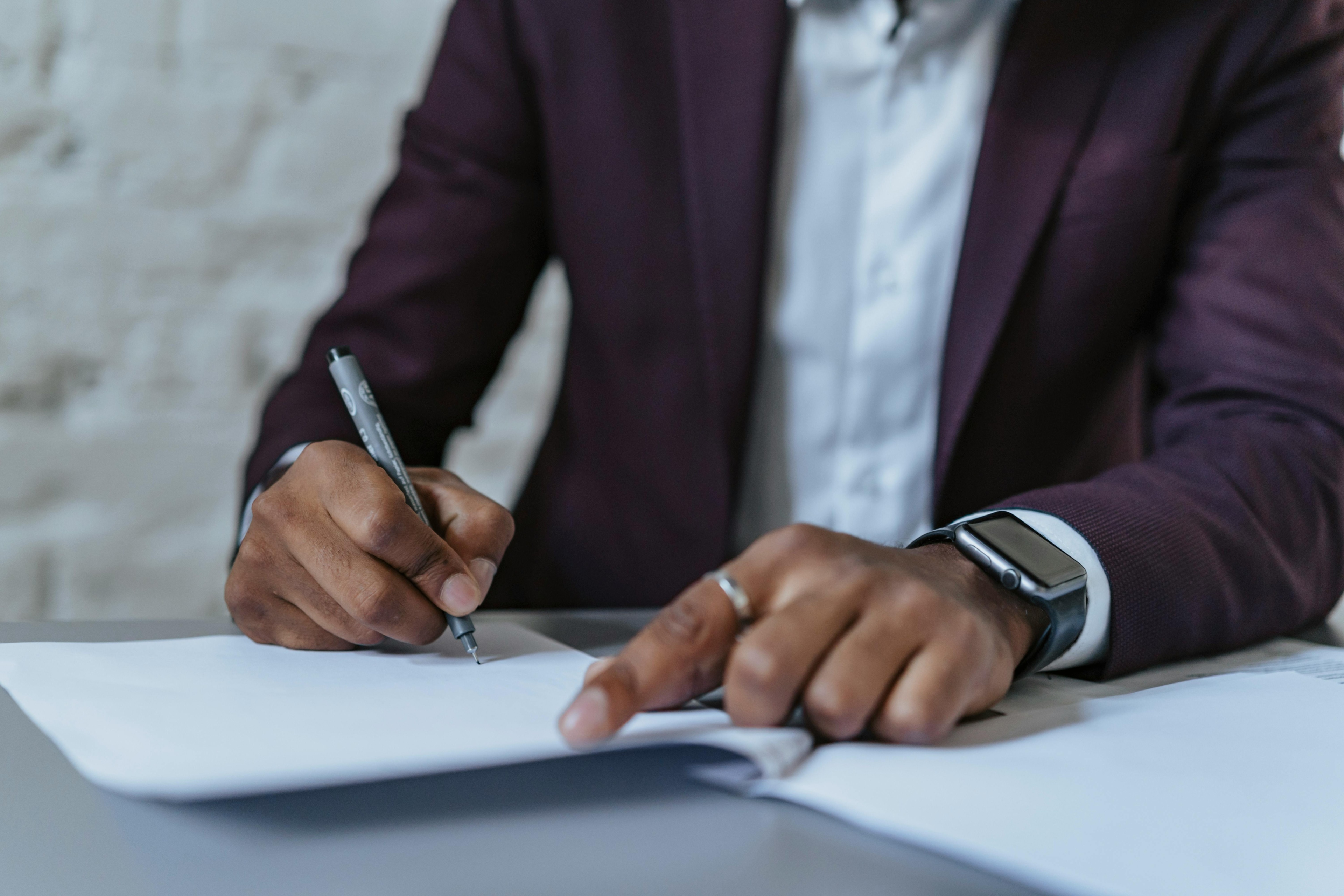 Man Writing On A Piece Of Paper
